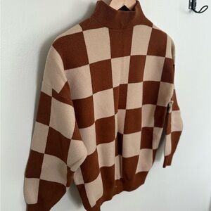 Neutral checkerboard sweater.